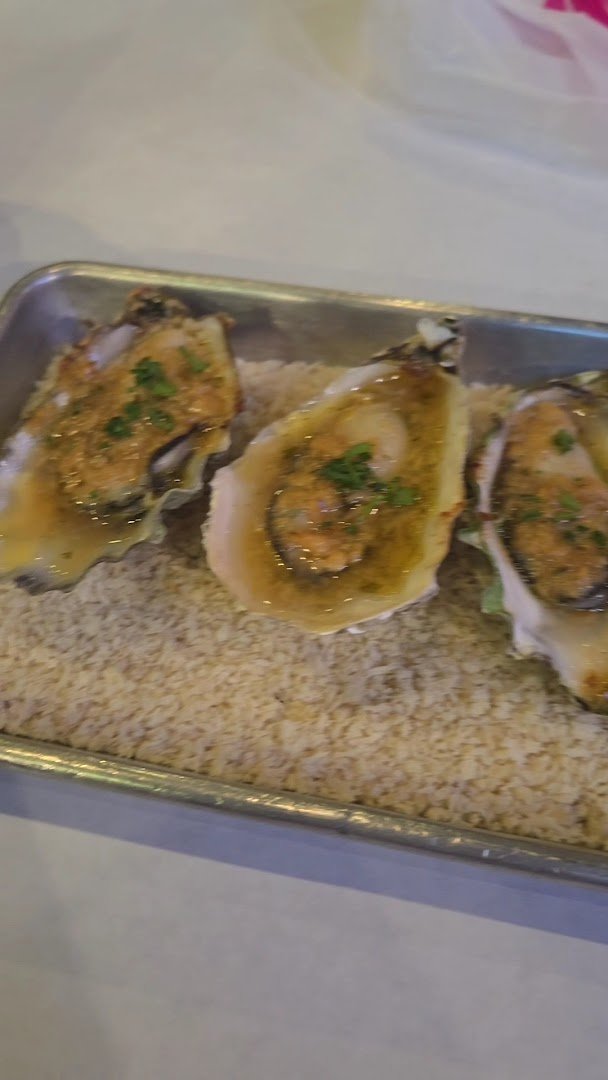 Plated Southern sides beside a seafood dish on a tabletop.